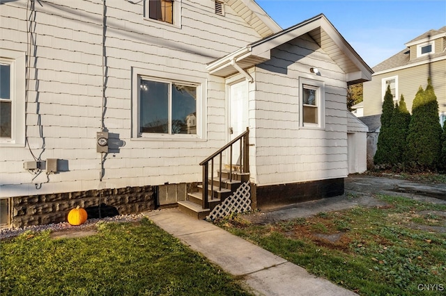 view of side of home with a lawn