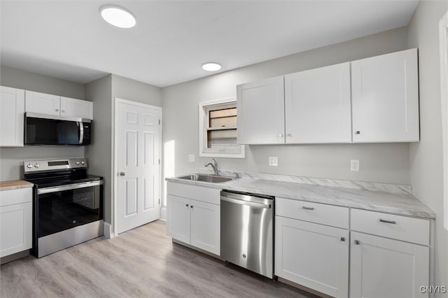 kitchen featuring white cabinets, light hardwood / wood-style floors, sink, and stainless steel appliances