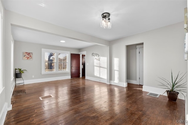 unfurnished living room with dark hardwood / wood-style flooring