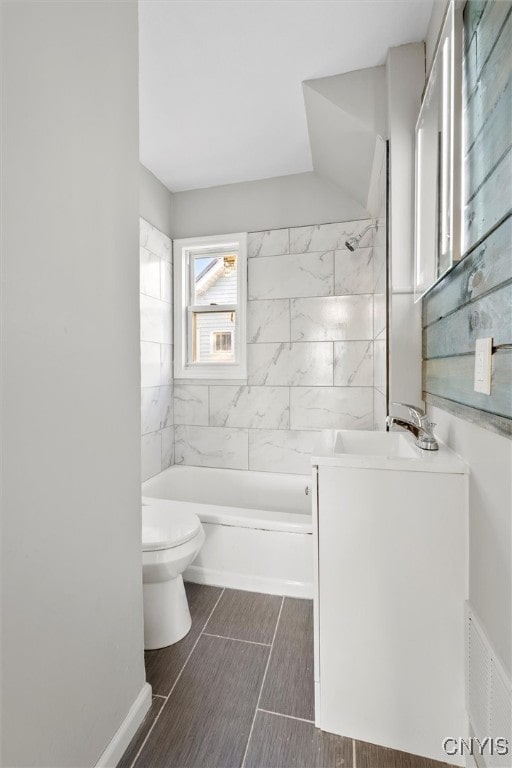 full bathroom featuring vanity, toilet, and tiled shower / bath