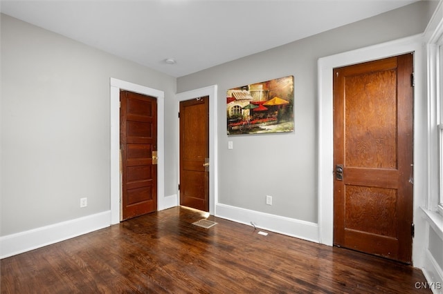 entrance foyer with dark hardwood / wood-style floors