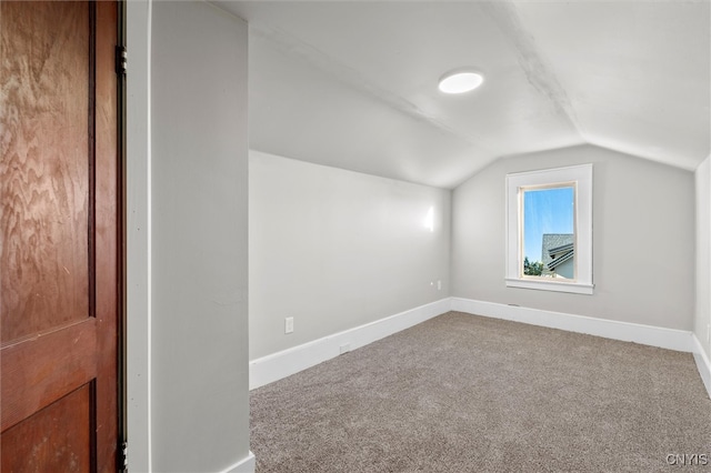 additional living space with carpet floors and lofted ceiling