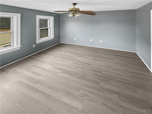 empty room featuring hardwood / wood-style floors and ceiling fan