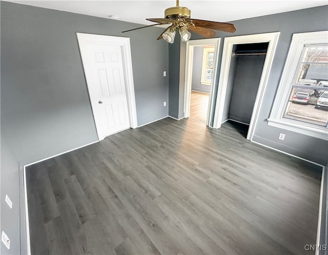 unfurnished bedroom with hardwood / wood-style floors, a closet, and ceiling fan