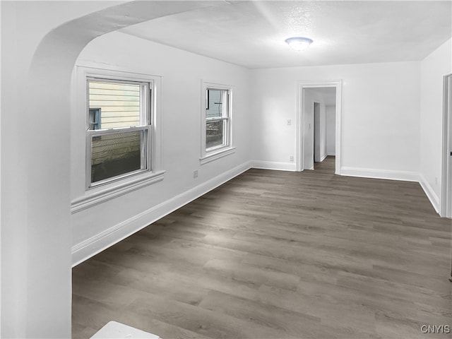 empty room featuring dark hardwood / wood-style flooring