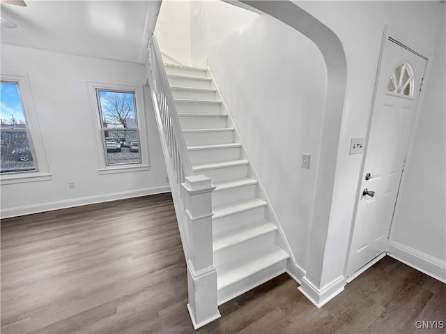 stairs featuring hardwood / wood-style floors