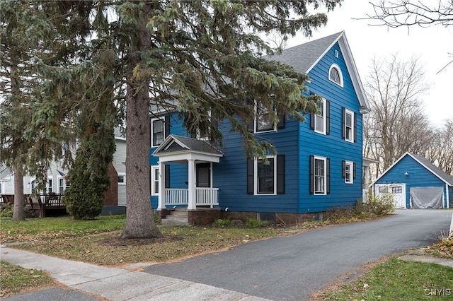 view of front of home with a garage and an outdoor structure