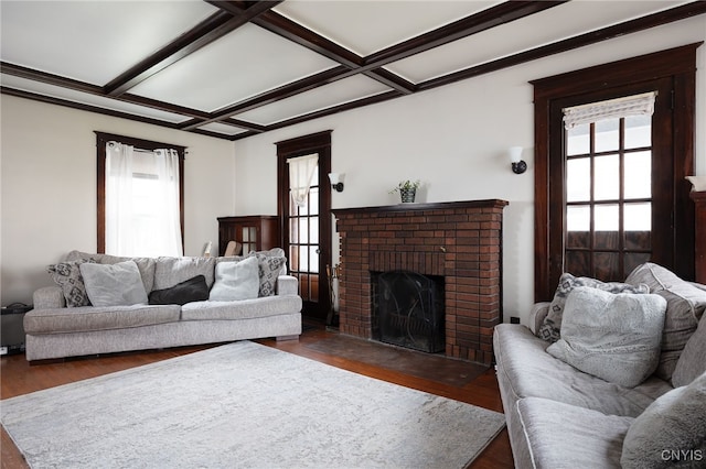 living room featuring plenty of natural light, dark hardwood / wood-style flooring, a fireplace, and coffered ceiling