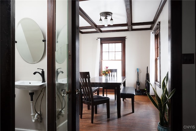 dining room featuring coffered ceiling, beamed ceiling, dark hardwood / wood-style floors, and sink