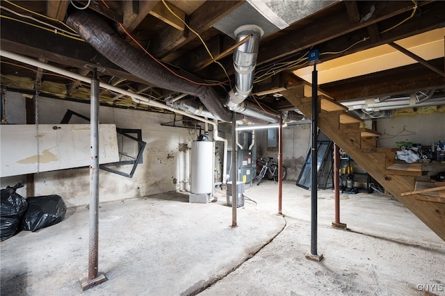 basement featuring heating unit, electric panel, and gas water heater