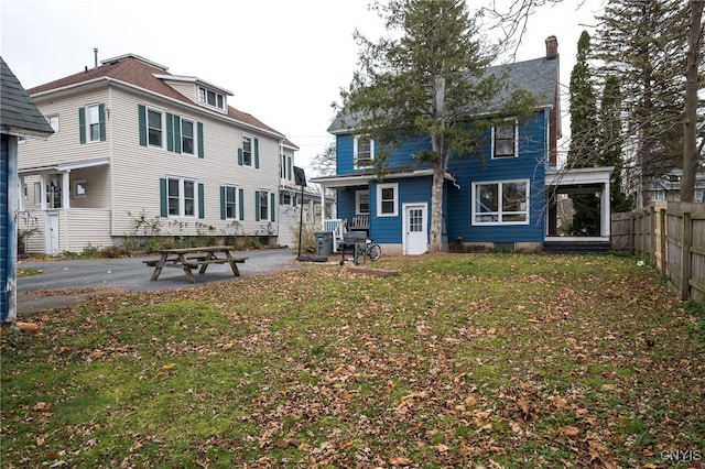 rear view of property featuring a yard and a patio area