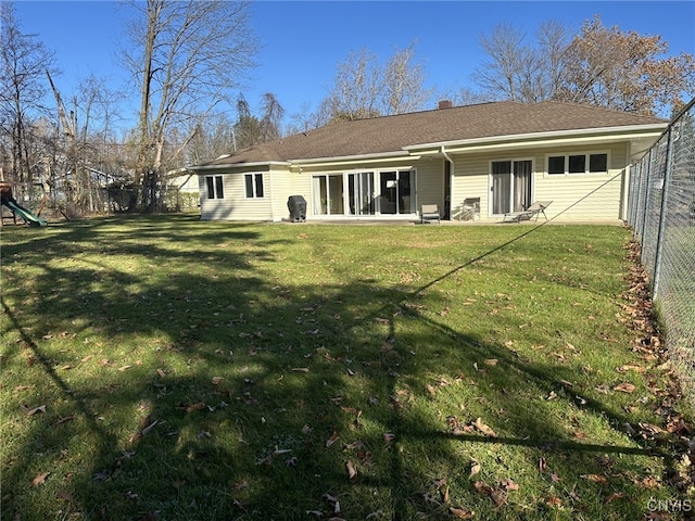 rear view of house with a lawn