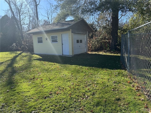 view of outbuilding with a garage and a lawn