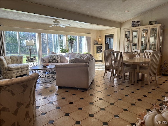 living room featuring a textured ceiling, ceiling fan, and lofted ceiling