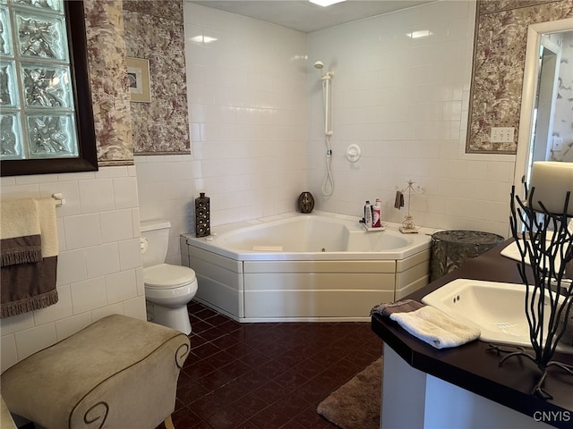 bathroom featuring a bathtub, vanity, tile walls, and toilet