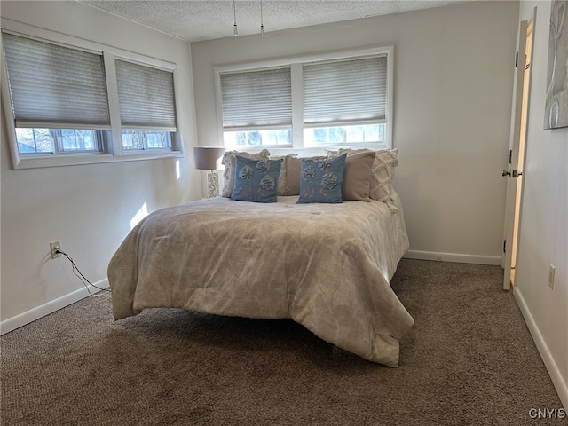 carpeted bedroom featuring a textured ceiling and multiple windows