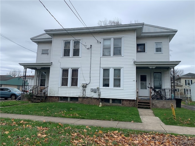 view of front of home featuring covered porch and a front yard