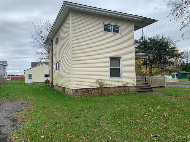 view of property exterior with a lawn