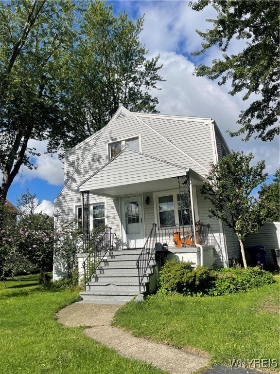 bungalow with a porch and a front lawn