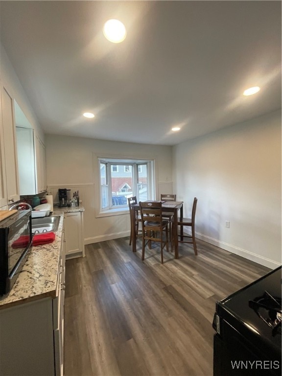 dining space with dark wood-type flooring