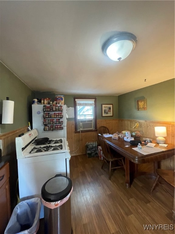 kitchen featuring dark hardwood / wood-style floors, cooling unit, white appliances, and washer / clothes dryer