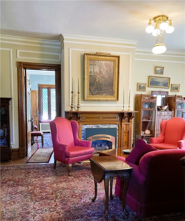 living area with ornamental molding and a high end fireplace