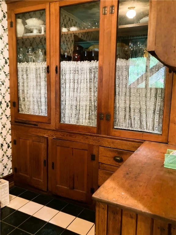 bar with wood walls and light tile patterned floors