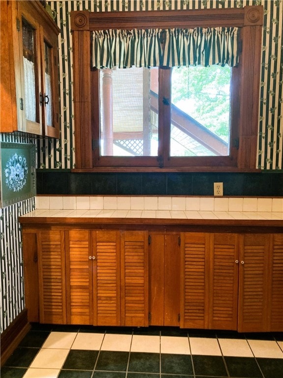 interior space featuring tile patterned flooring and backsplash