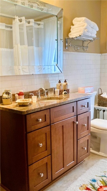 bathroom featuring decorative backsplash, vanity, and toilet