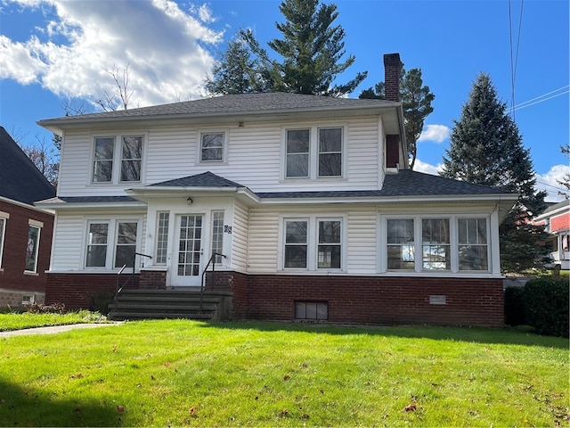 back of house with a lawn