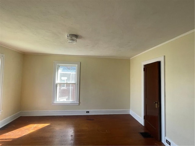 unfurnished room featuring crown molding and dark hardwood / wood-style floors