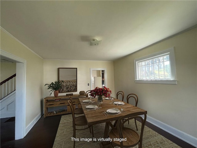 dining room featuring ornamental molding and dark hardwood / wood-style flooring