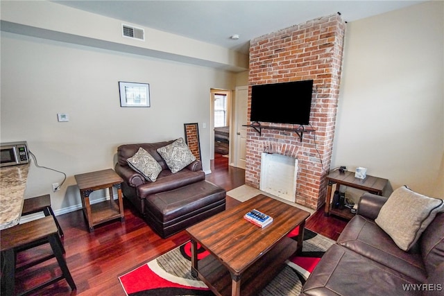 67 Harvard Pl, Buffalo, NY 14209 - living room with dark hardwood / wood-style flooring and a fireplace