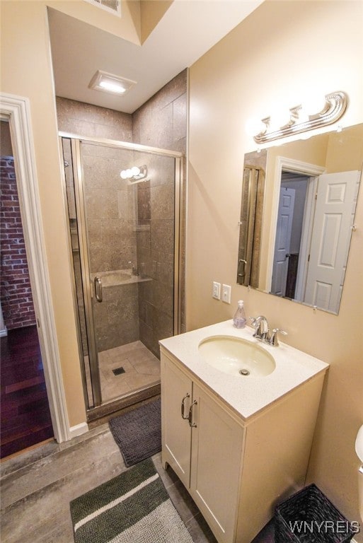 67 Harvard Pl, Buffalo, NY 14209 - bathroom featuring wood-type flooring, vanity, and an enclosed shower