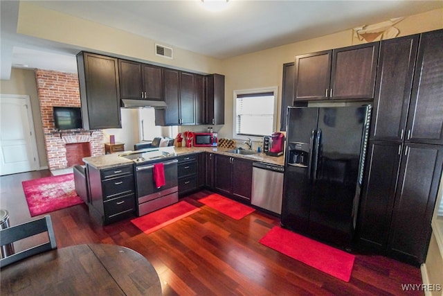 67 Harvard Pl, Buffalo, NY 14209 - kitchen featuring sink, dark hardwood / wood-style flooring, a fireplace, dark brown cabinets, and appliances with stainless steel finishes