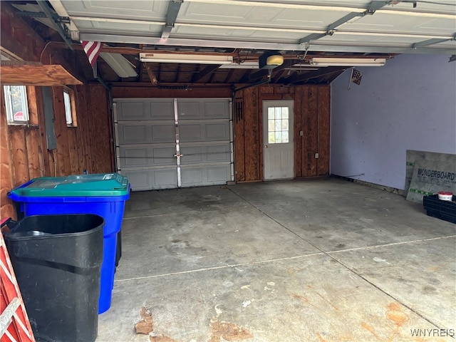 garage featuring wood walls and a garage door opener