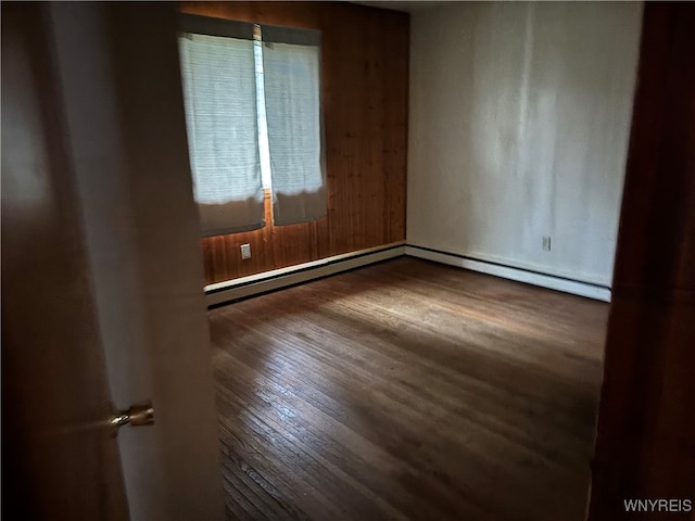 unfurnished room with wood-type flooring