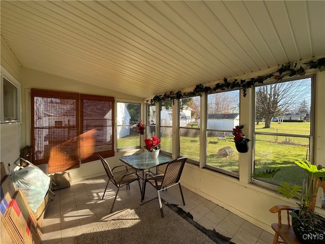 sunroom with plenty of natural light and lofted ceiling