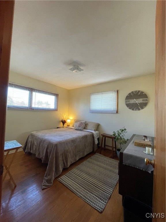 bedroom with dark hardwood / wood-style floors