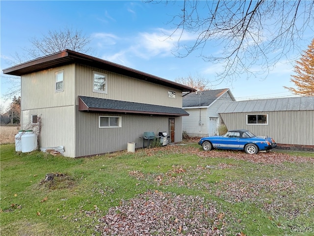 back of house with a lawn