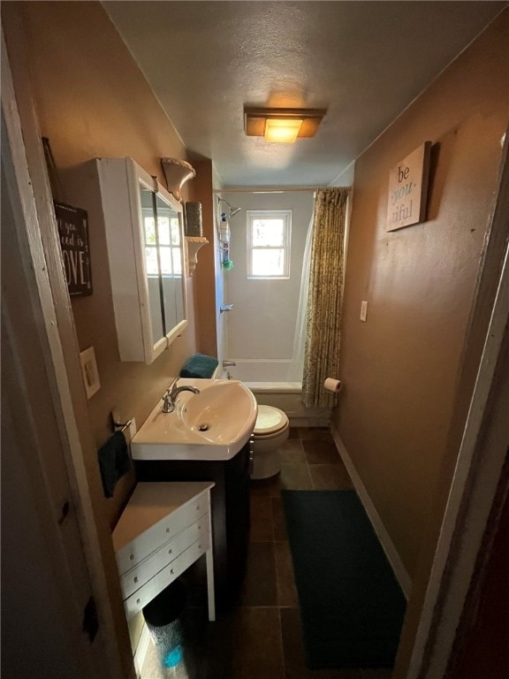 full bathroom with tile patterned flooring, shower / tub combo, vanity, and toilet