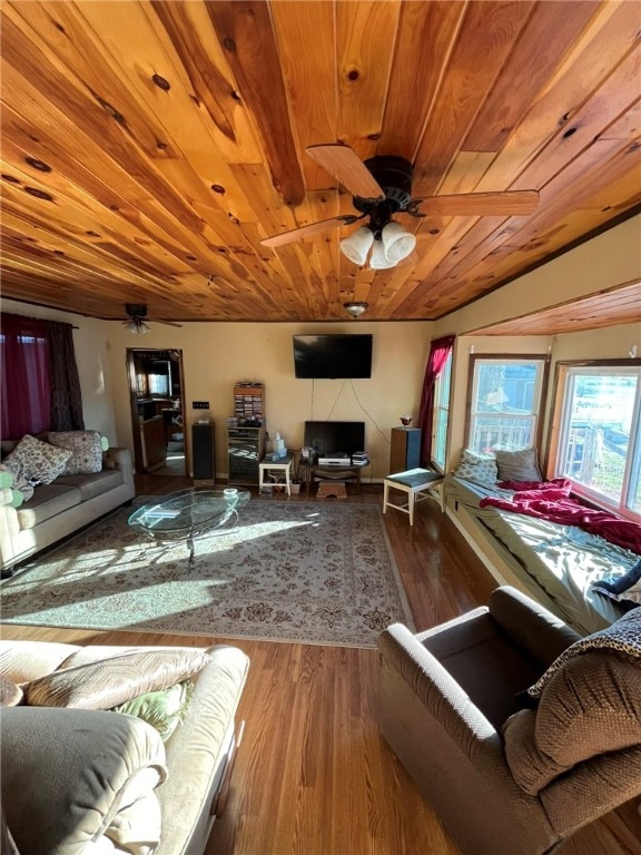 living room with ceiling fan, wood-type flooring, and wood ceiling