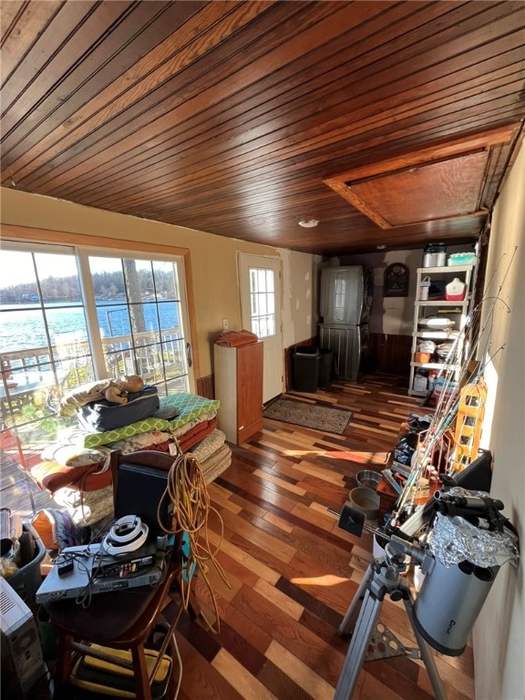 interior space featuring hardwood / wood-style flooring, a water view, and wood ceiling