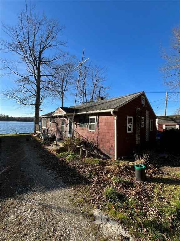 view of property exterior featuring a water view