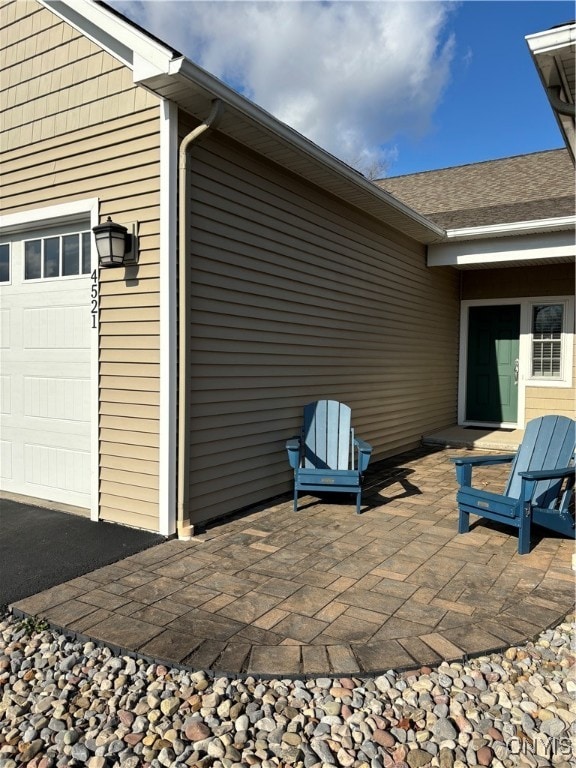 view of patio featuring a garage