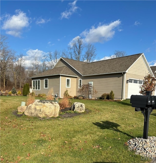 view of home's exterior with a garage and a lawn