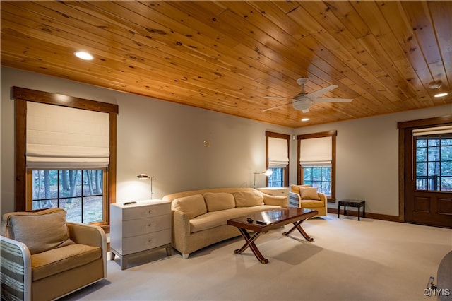 carpeted living room featuring ceiling fan, wood ceiling, and a wealth of natural light