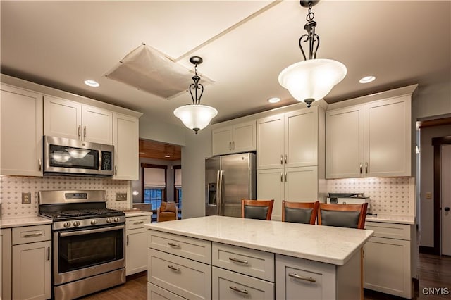 2773 S Shore Rd, Webb, NY 13420 - kitchen featuring stainless steel appliances, decorative backsplash, hanging light fixtures, recessed lighting, and a center island