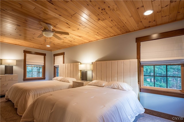 bedroom with carpet, ceiling fan, and wooden ceiling