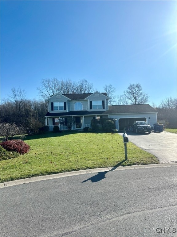 view of front property featuring a front yard, a garage, and covered porch